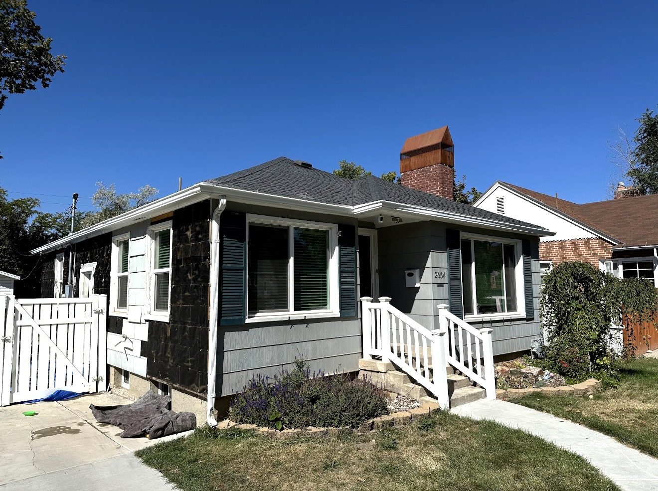 Cottage home before, old worn gray siding