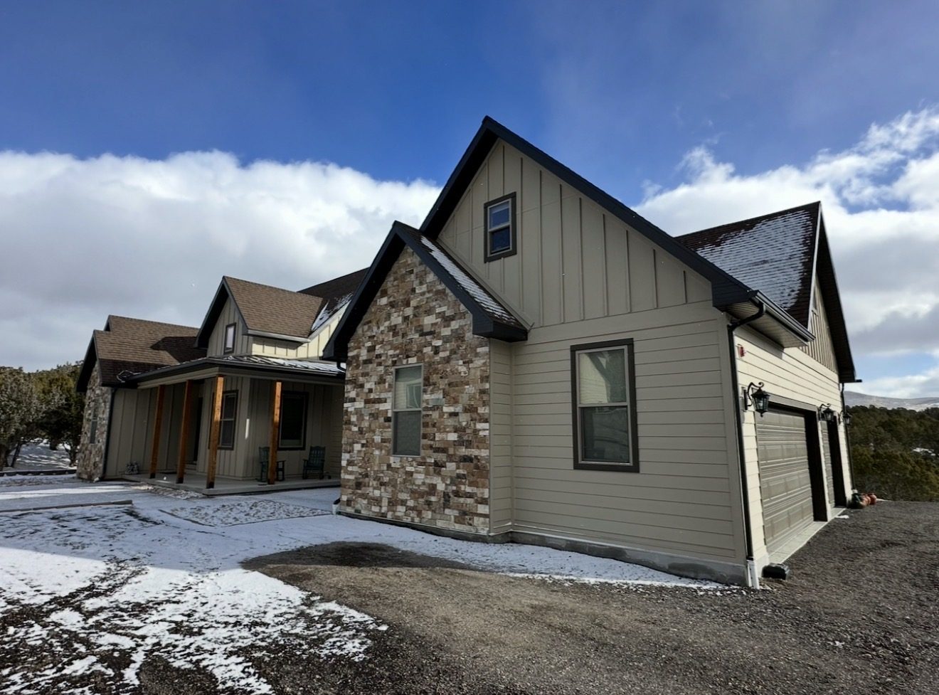 New custom home in Herriman with tan board and batten siding and stone accents