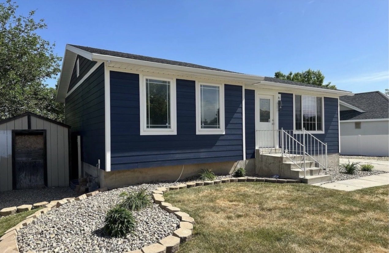 Home after, full new navy blue siding replacement